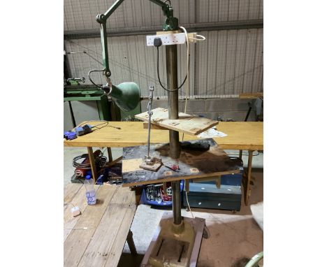 A tall wheeled workstation complete with lamp