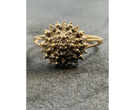 A 9ct gold and diamond cluster ring, size p. Marked 375 dia 0.10.