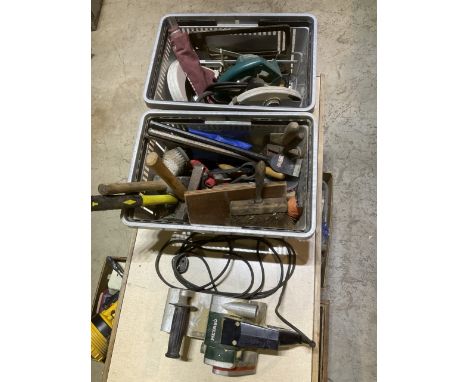 Two plastic crates containing a Metabo inch industrial belt sander a black and decker circular saw and a range of builders ha
