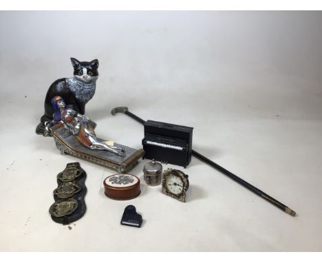 A painted iron cat door stop, also with a figure of Cleopatra, a pewter topped walking stick, a piano money box, and other it