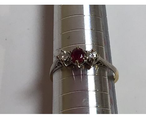 An 18 carat gold diamond and ruby ring. Total weight 2 gm. Size 7 
