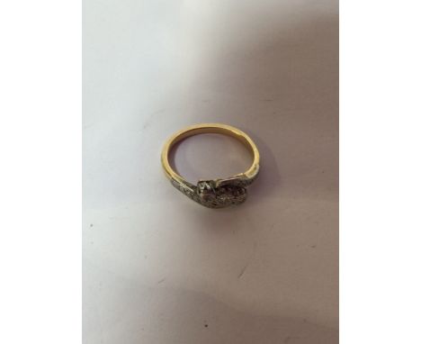 A diamond trilogy twist ring, gold metal - un hallmarked. Size 6.5. Total weight 3 gm