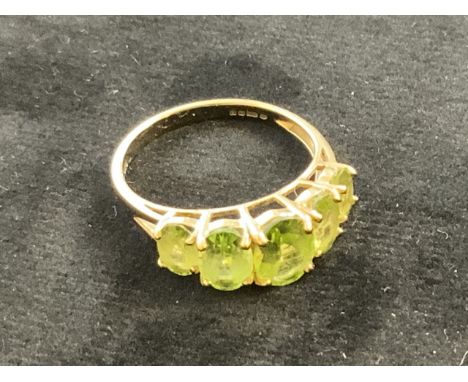 A 9ct gold peridot five stone ring. Size R.