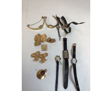 Four pairs of Ethiopian decorative gold earclips, 8 various wristwatches and a pendant watch. Watches include Timex, Oris Sta