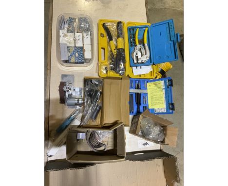 A box containing sets of various flaring tool is a range of wood screws a mini linishing sander
