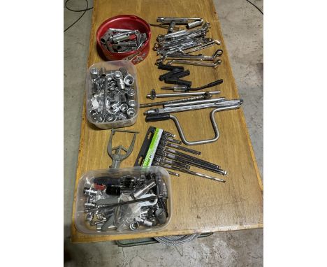 A large assortment of mechanics and garage tools including ratchets sockets extension bars and spanners