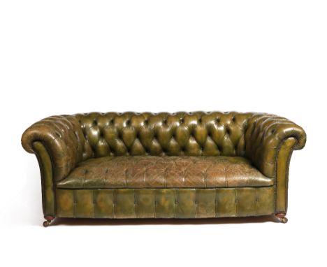 A Victorian green leather upholstered Chesterfield sofa on turned feet and castors, 80cm high x 203cm wide 
