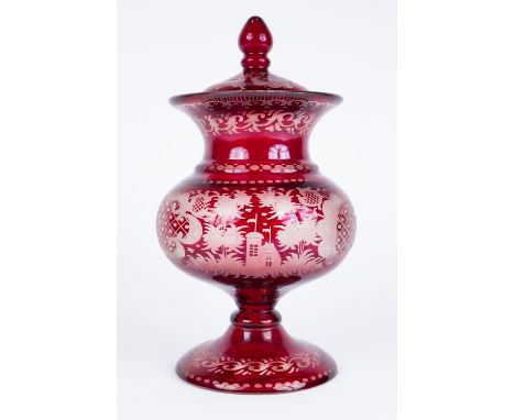 A Bohemian ruby overlaid glass oil lamp base 43cm and a ruby flash glass vase and cover, 25cm (2)