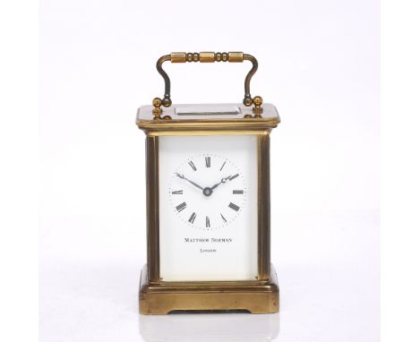 A brass carriage clock with enamel dial by Matthew Norman of London