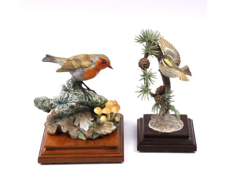 A Royal Worcester model 'Robin' on a wood stand and a 'Gold Crest' (2)