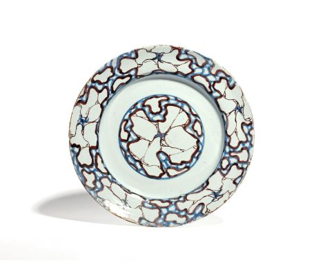 An unusual delftware charger  c.1750-60, probably London, decorated to the well and rim with a cracked ice design in blue and