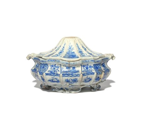 A large and early Bow blue and white tureen and cover  c.1753-55, the elaborate silver shape painted with alternating panels 