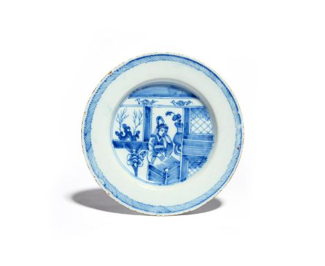 A good delftware plate  c.1760, painted in underglaze blue with a Chinese lady seated in an interior beside a latticed window