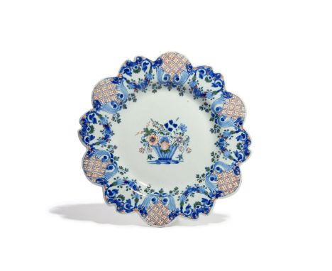 A delftware plate  mid 18th century, Liverpool or Bristol, decorated in the manner of Rouen faïence with a delicate basket of