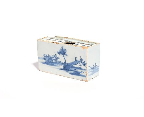 A delftware flower brick  c.1750-60, each long side painted in blue with large low huts beneath trees, the short sides with t