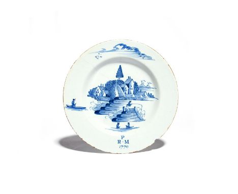 A Bristol delftware marriage plate  dated 1770, painted in blue with figures in boats and fishing from an island before build