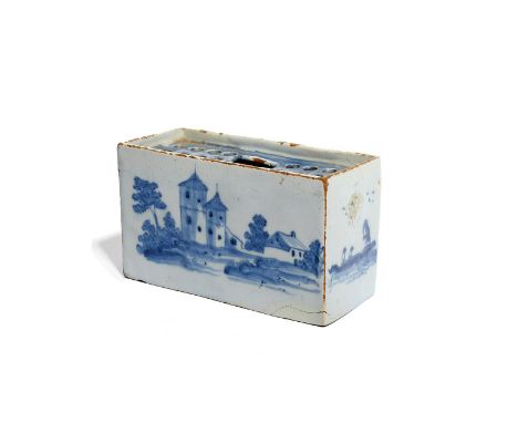 A delftware flower brick  c.1750-60, painted with towers and other buildings to the long sides, the short sides with a figure