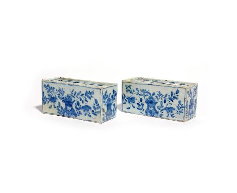 A pair of delftware flower bricks  c.1740, of small rectangular form, each painted in blue with flowering branches issuing fr