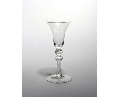 A Newcastle light baluster glass mid 18th century, with a bell bowl raised on a slender baluster stem with a teared ball knop