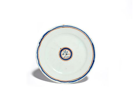 A delftware plate  dated 1723, painted in blue with the initials RG beneath 'IHS' and a cross, above the date 1723, all conta
