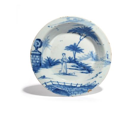 A delftware deep dish  c.1760, probably Bristol, the circular form with deep rounded sides, painted in blue with a European f