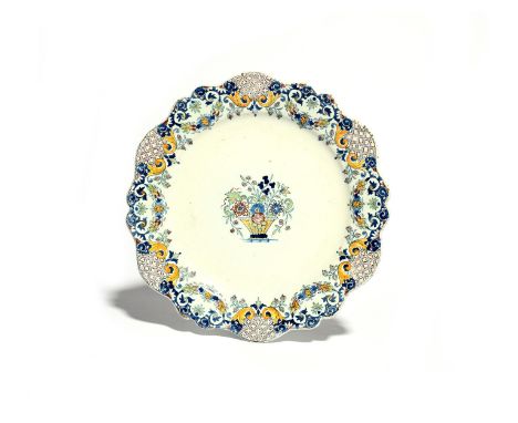 A delftware plate  mid 18th century, Liverpool or Bristol, decorated in the manner of Rouen faïence with a delicate basket of