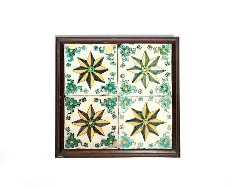 A panel of four Continental faïence tiles  18th/19th century, painted in blue, green, yellow and manganese, each with an eigh