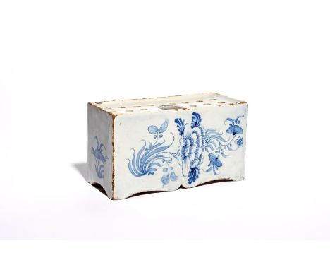 A large delftware flower brick  c.1750-60, probably Bristol, simply painted in blue with sprays of peony and other flowers, w