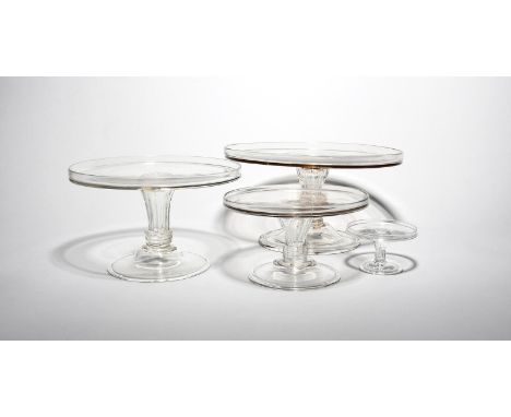 Three glass tazzae  mid 18th century, in three sizes, with flat circular tops with galleried rims, raised on moulded pedestal