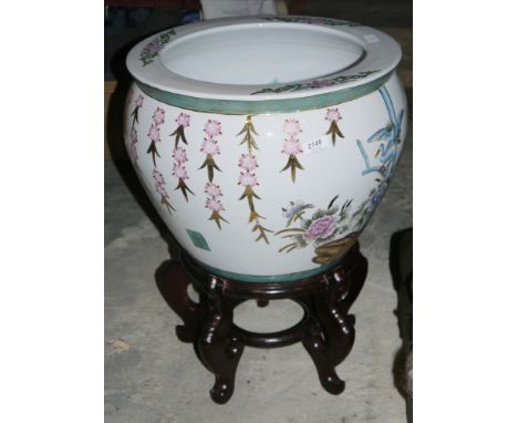 Contemporary Chinese-style fish bowl on wooden stand, decorated with famille rose style flowers and dish, on scroll stand, 56