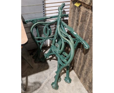 Pair of early 20th century Victorian style green-painted scroll-shaped bench ends and two table base supports, together with 