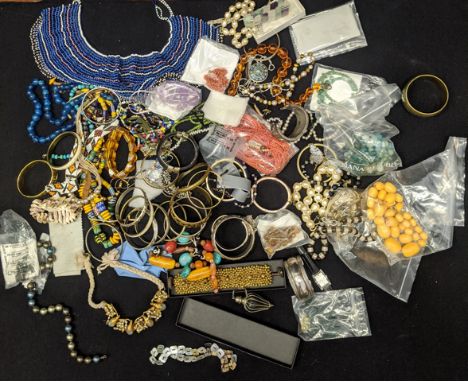 A large collection of jewellery to include a Middle Eastern silver bangle, tribal pieces, beads etc.