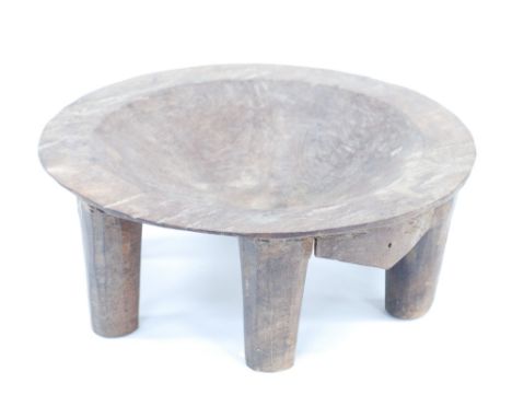 NIGERIAN CARVED HARDWOOD SIX LEGGED NUPE STOOL with dished centre to the circular top, 3 3/4" (9.5cm) high, 10" (25.4cm) diam