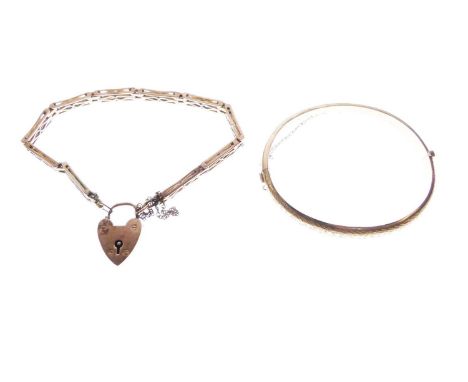 Edwardian 9ct gold hinged bangle, Chester 1903, together with a yellow metal panel-link bracelet, the heart shaped padlock st
