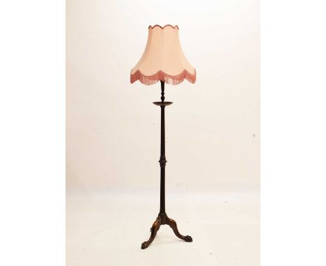 Reproduction mahogany standard lamp with pink shade, raised on tripod supports with claw and ball feet, 180cm high (overall)