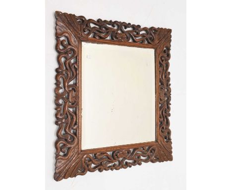 Carved and pierced hardwood framed wall mirror with bevelled glass plate, 76cm x 70cm