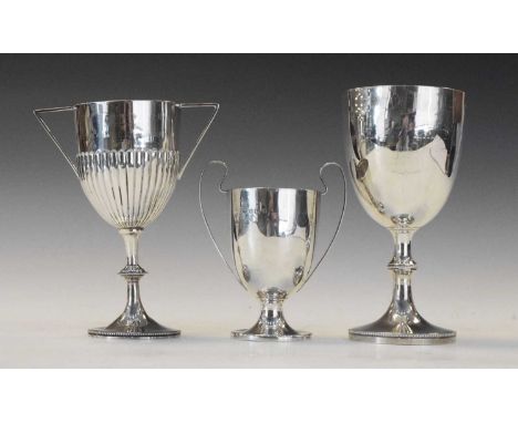 Late Victorian silver trophy, London 1872, together with two George V examples, 18.5cm high and smaller, all with wooden base