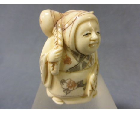 A Signed Ox Bone Netsuke of a Lady with Sack 