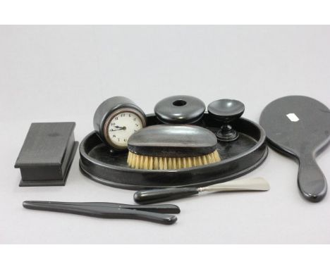 An early 20th century Ebony Dressing Table Set comprising clock, hand mirror, glove stretchers, show horn, tray, trinket box 