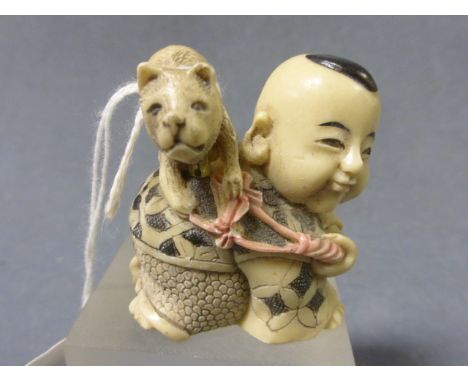 A Wooden Carved Netsuke depicting a Frog with a Snail on its back 
