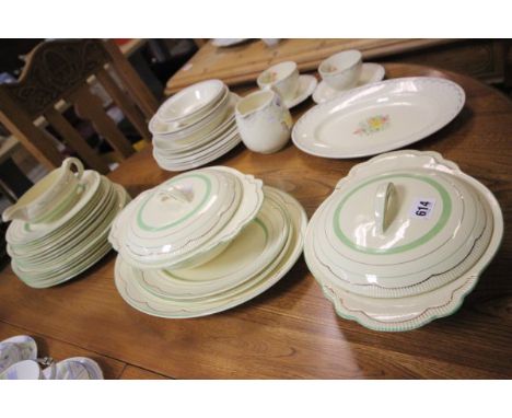 A Clarice Cliff Part Dinner Service, Green and Gilt on Cream Background comprising two treens and lids, three graduating meat