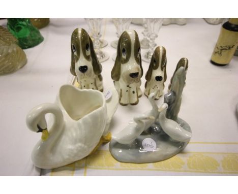 A Sylvac Swan, Four Szeiler Dogs and a Nao Figure of Geese 