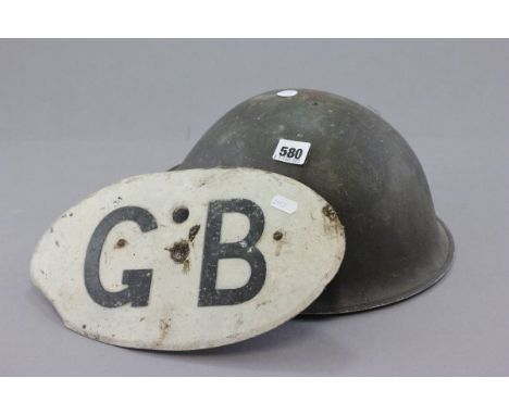 A Military Helmet and GB Enamel Sign 