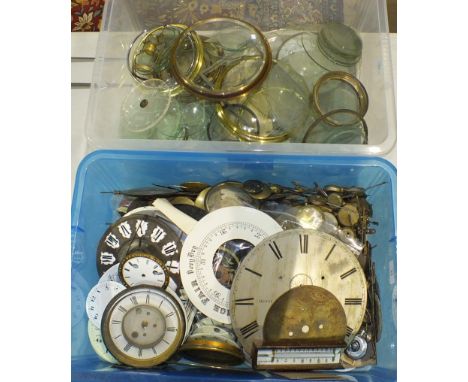 A collection of clock pendulums, clock dials, bezels, etc.
