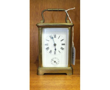 A Continental brass carriage clock, the dial with Roman numerals and subsidiary alarm dial, the movement striking on a bell u