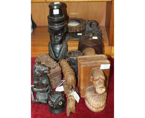 A Black Forest carved wood sitting bear napkin or salt holder, 18cm high, a pair of hardwood book ends carved with tribal bus