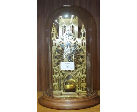 A Hermle Franklin Mint York Minster Cathedral skeleton clock on circular wooden base with glass dome, 29cm high.