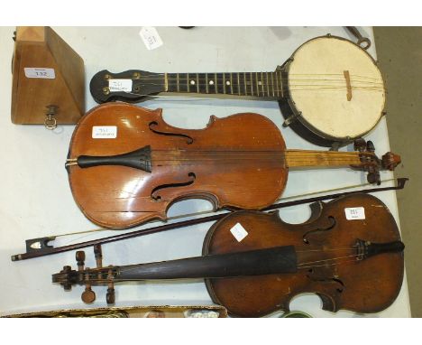 A full-size violin with paper label, Apres Guarelagnini Lorengo, another violin, a bow, a small banjo, (all af) and a metrono