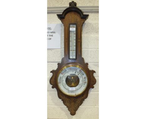 An inlaid mahogany aneroid barometer/thermometer, 32cm wide, 86cm high.