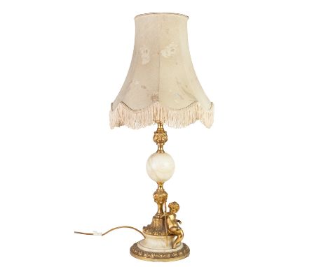 ALABASTER AND GILT METAL MOUNTED LARGE TABLE LAMP, modelled with a seated putti holding a trident to the base, and the shade,